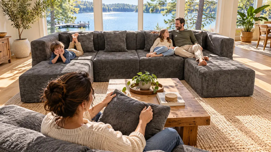 Family of four relaxing on a dark grey MONVANE U-Shaped Modular Couch arranged around a coffee table in an open living room