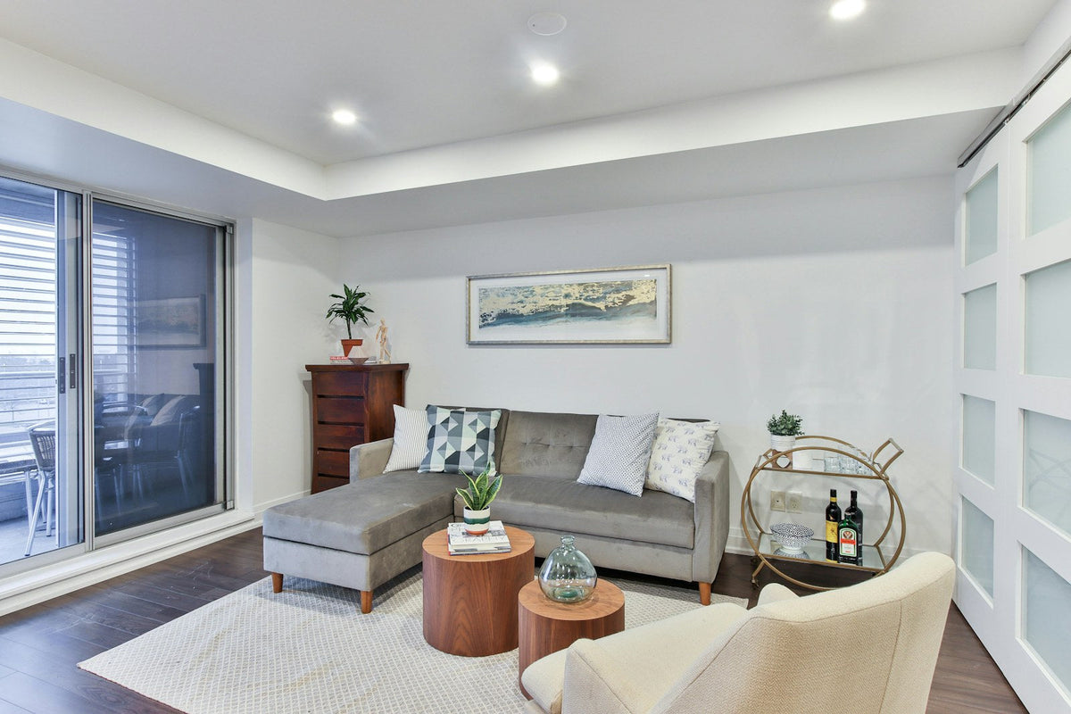 Gray chaise sofa with separate upright seating beside its extended lounge surface.