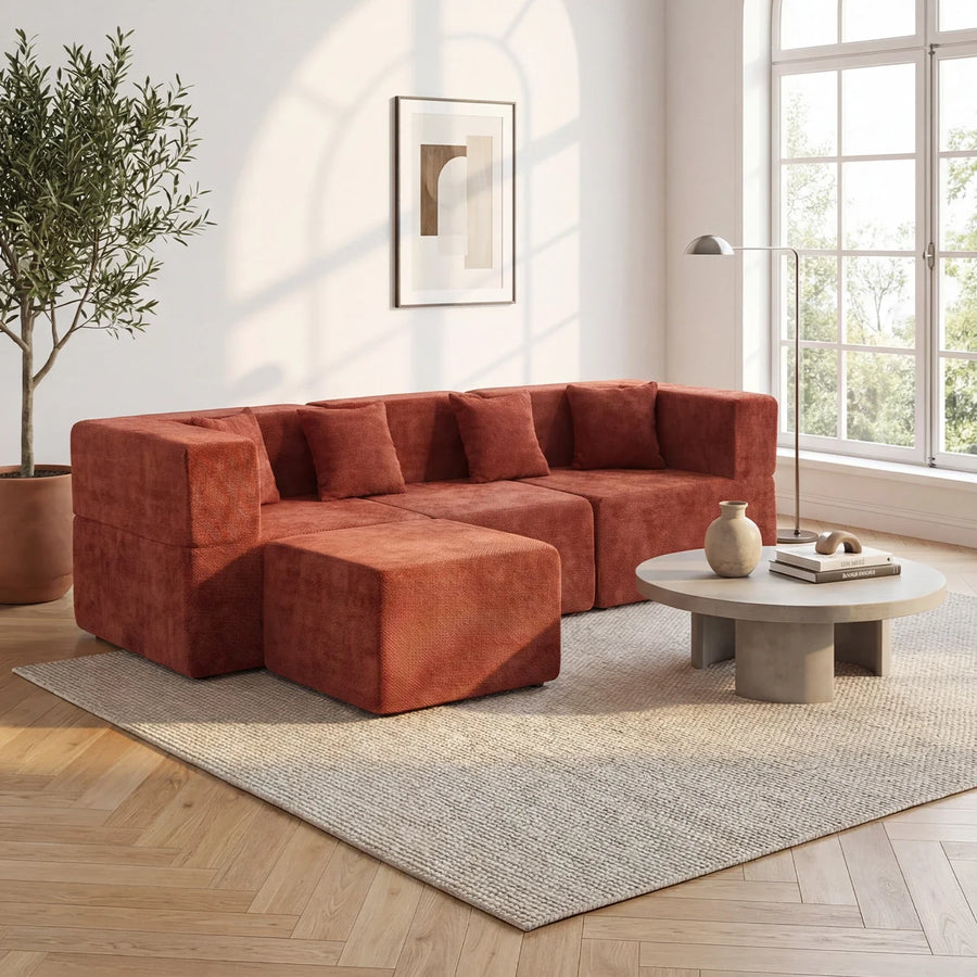 Rust-red L-shaped modular sectional with a forward return in a bright living room