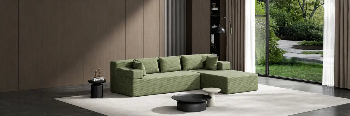 Green L-shaped sectional sofa in a modern living room.