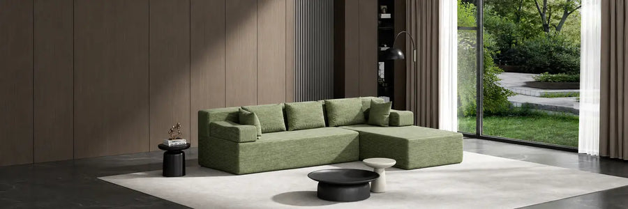 Green L-shaped sectional sofa in a modern living room.