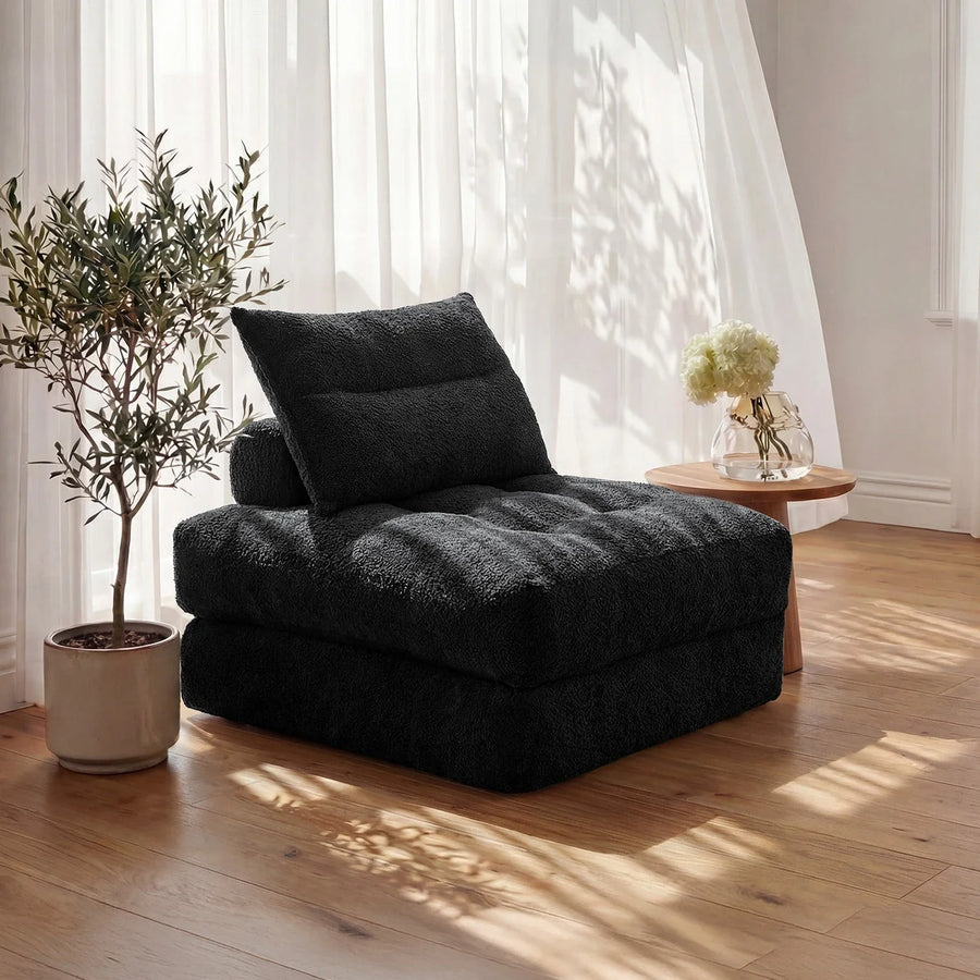 Black Monvane Oversized Sofa Bed in its folded seating state in a bright room.