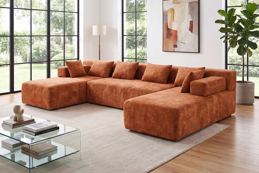 Orange Monvane U-shaped sectional with matching loose pillows distributed along the back and open seats.