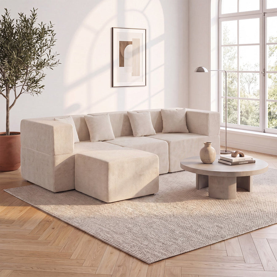 Cream Monvane L-shaped modular couch with a projecting square return in a bright living room.