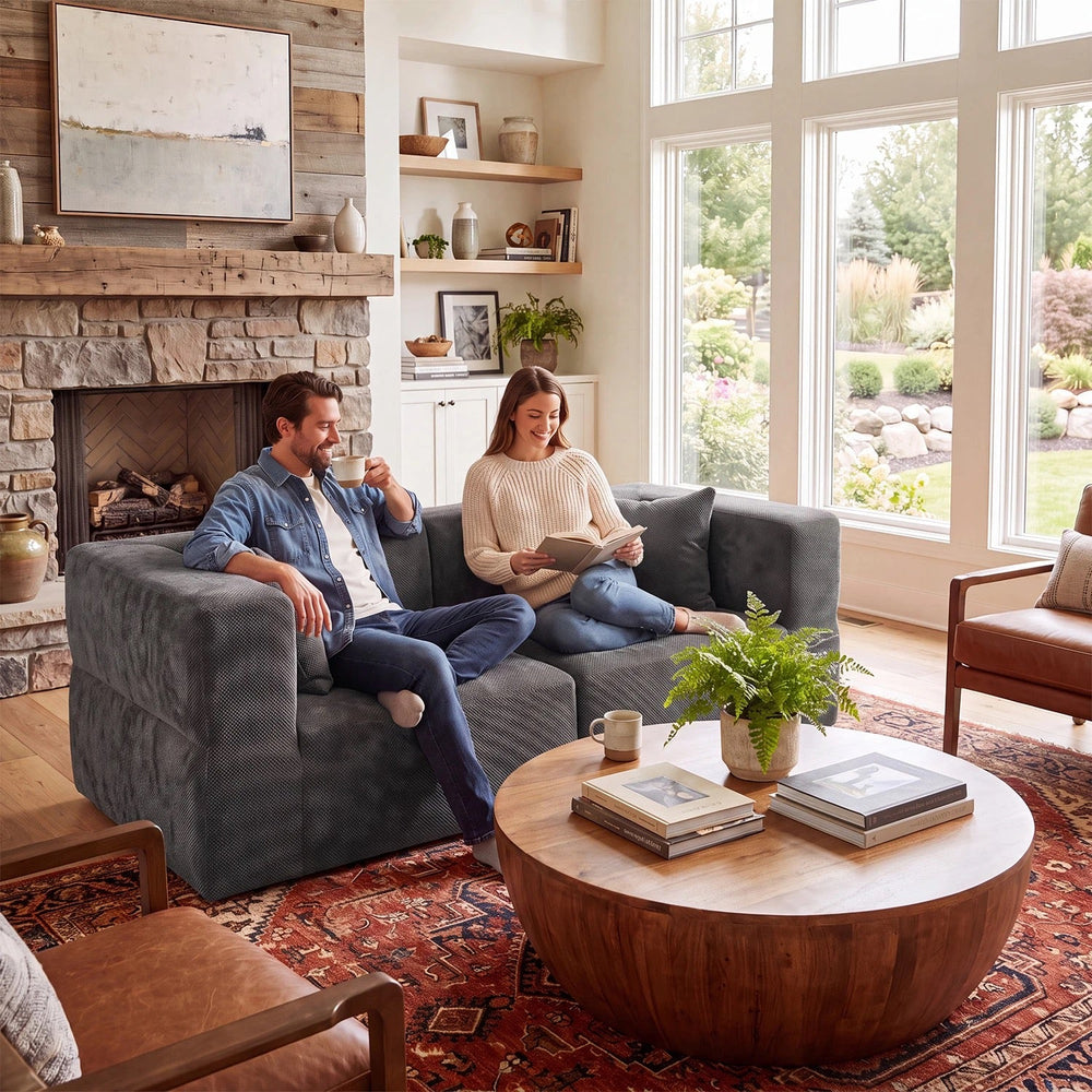Two adults sitting in relaxed positions on a dark gray Monvane 75-inch two-seat loveseat.