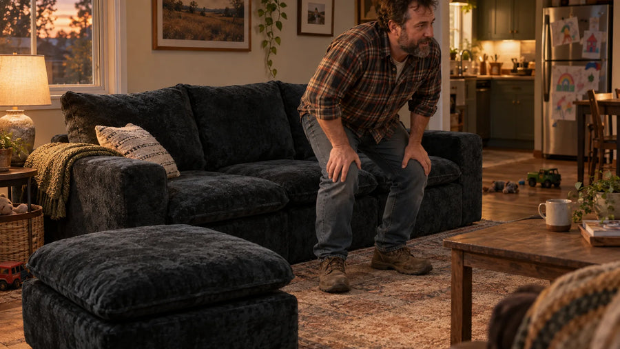 Man standing up from a dark grey MONVANE Cushioned Modular Sofa while the seat cushion stays in place (AI-generated illustration, not a customer photo)