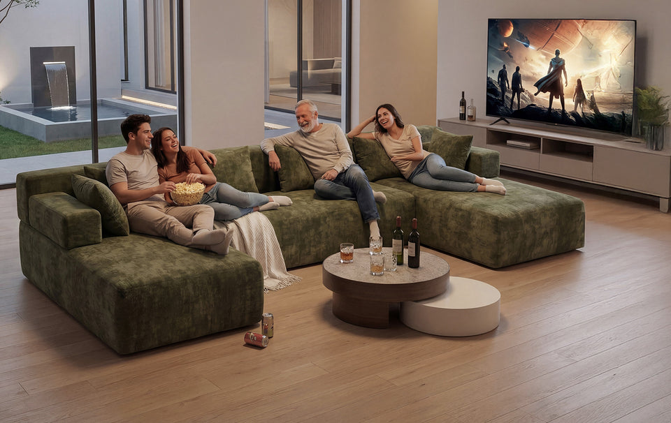 A family relaxing together on a green Monvane sectional during a movie night
